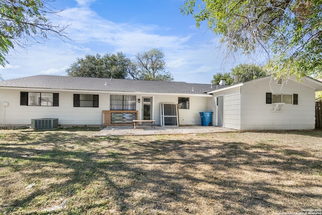 rear view of property with a yard, a patio, and central AC unit