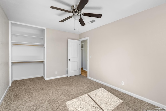 unfurnished bedroom with ceiling fan, carpet floors, and a closet