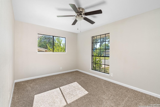 carpeted empty room featuring ceiling fan