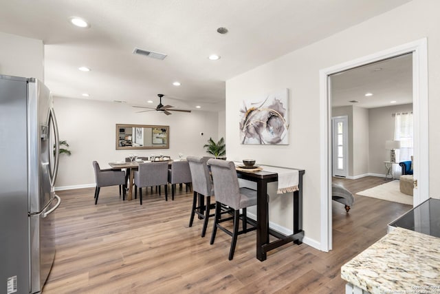 dining room featuring dark hardwood / wood-style flooring and ceiling fan