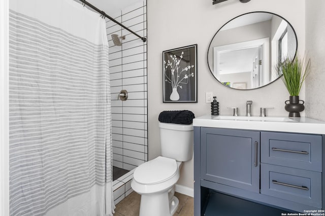 bathroom featuring walk in shower, tile patterned flooring, vanity, and toilet