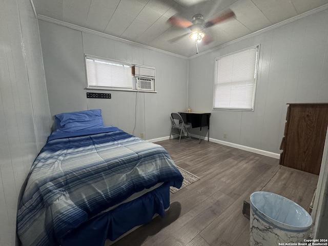 bedroom with ceiling fan, wood-type flooring, and ornamental molding