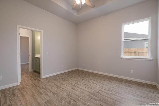 spare room with ceiling fan and light wood-type flooring