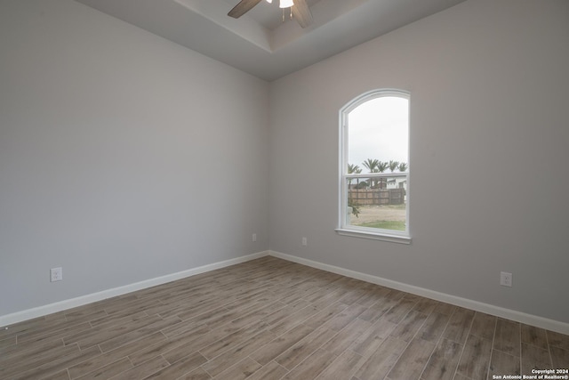 empty room with light wood-type flooring and ceiling fan