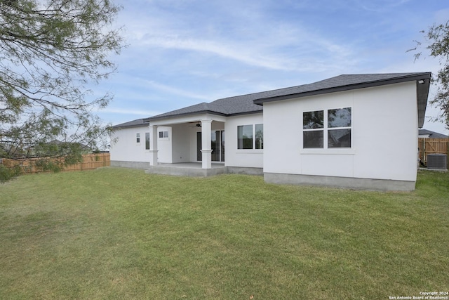 back of property featuring ceiling fan, a yard, a patio, and central AC unit