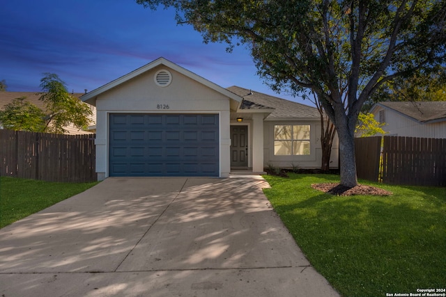 single story home with a yard and a garage