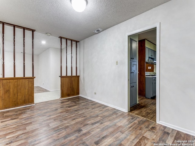 unfurnished room featuring a textured ceiling and dark wood-type flooring