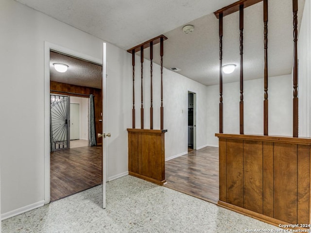 interior space with wood-type flooring and a textured ceiling