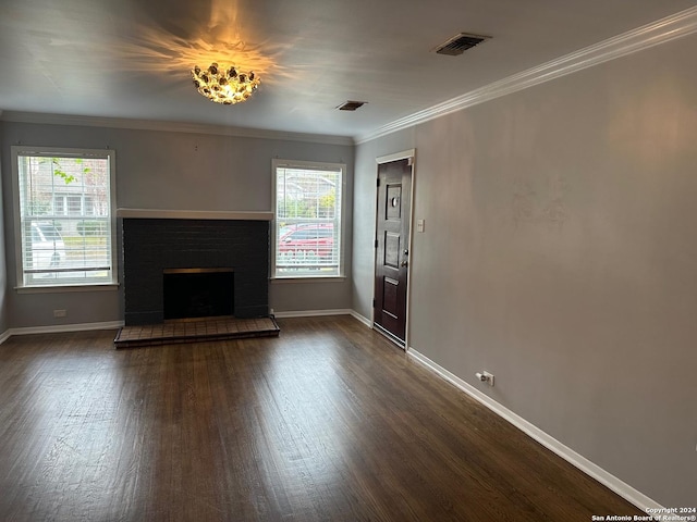 unfurnished living room with a tile fireplace, dark hardwood / wood-style floors, and ornamental molding