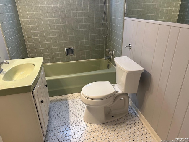 full bathroom featuring tile patterned floors, vanity, toilet, and tiled shower / bath combo