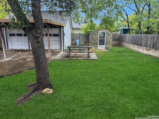 view of yard featuring a garage and an outdoor structure