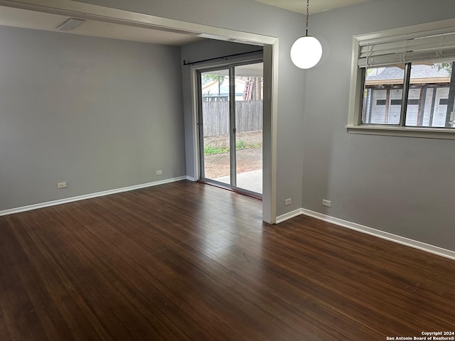 unfurnished room featuring dark hardwood / wood-style flooring