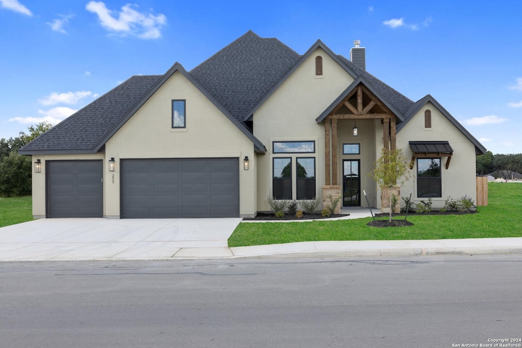 view of front of house featuring a front lawn and a garage