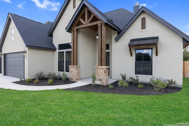 view of front of house with a garage and a front lawn