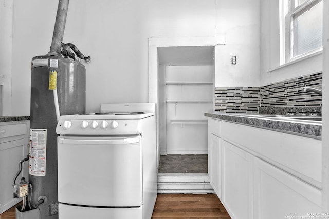 kitchen featuring electric range, white cabinetry, tasteful backsplash, water heater, and dark hardwood / wood-style flooring