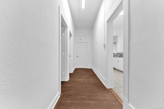 corridor with wood-type flooring