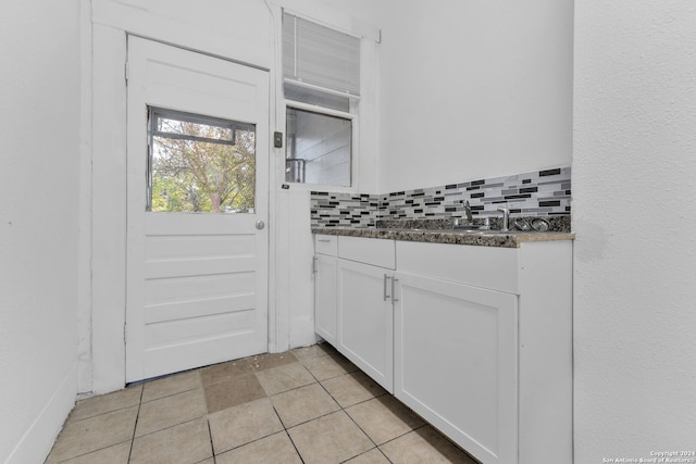 kitchen with decorative backsplash and white cabinetry