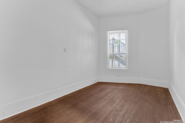 spare room with dark hardwood / wood-style flooring