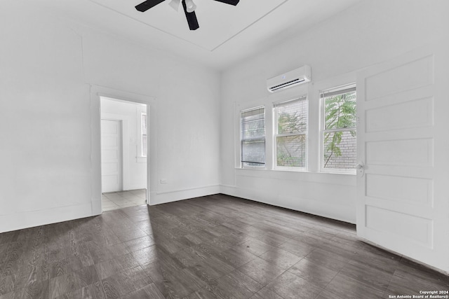 spare room with a wall mounted air conditioner, dark hardwood / wood-style flooring, and ceiling fan