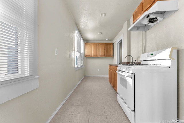 kitchen featuring gas range gas stove and light tile patterned floors