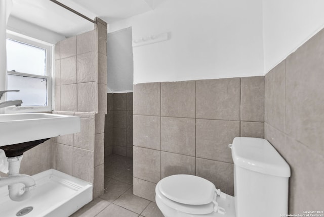 bathroom with tile patterned flooring and tile walls