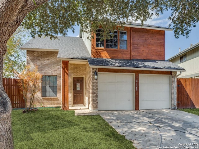 view of front of home featuring a front yard and a garage