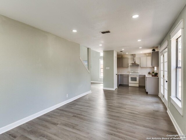 unfurnished living room with hardwood / wood-style flooring and a wealth of natural light