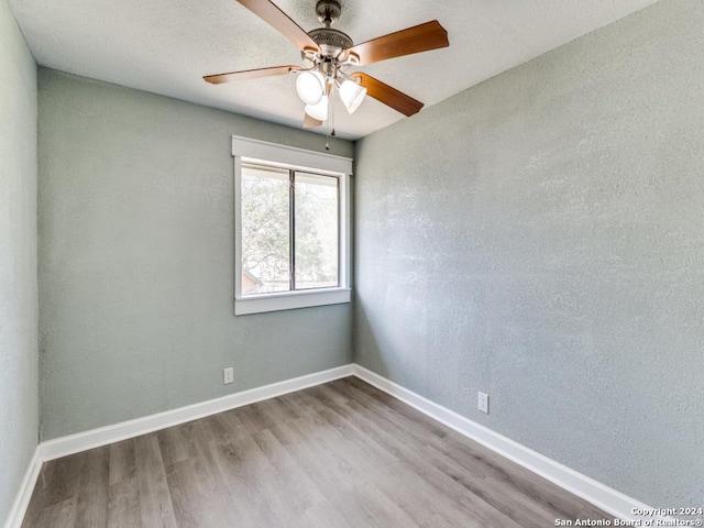 empty room featuring ceiling fan and light hardwood / wood-style flooring