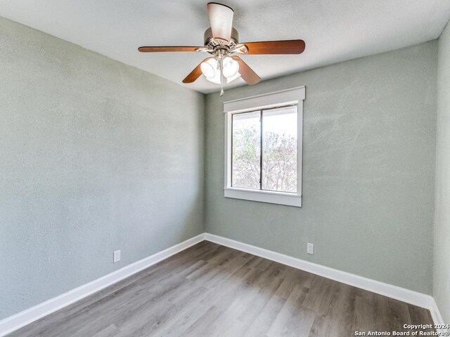 unfurnished room featuring hardwood / wood-style floors and ceiling fan