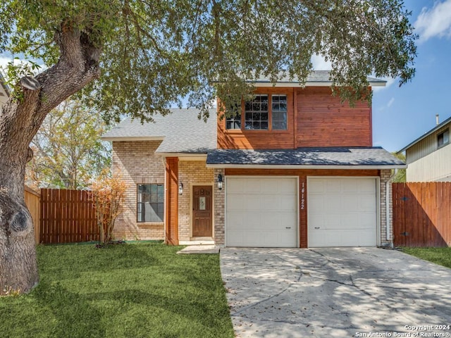 view of front property featuring a front yard and a garage