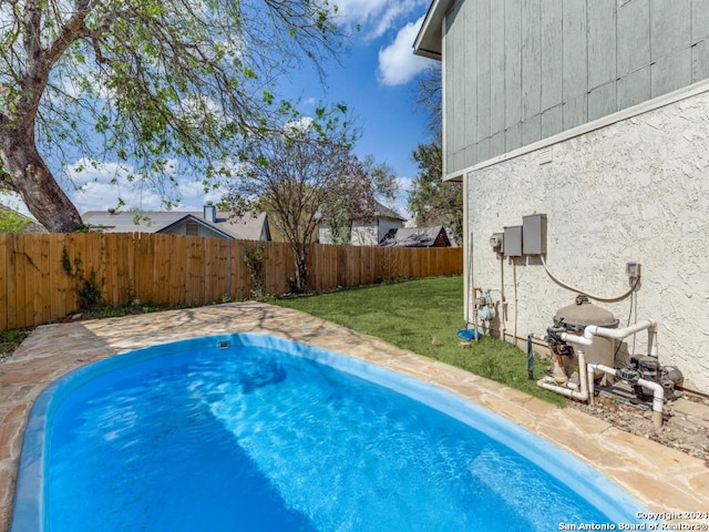 view of pool with a yard