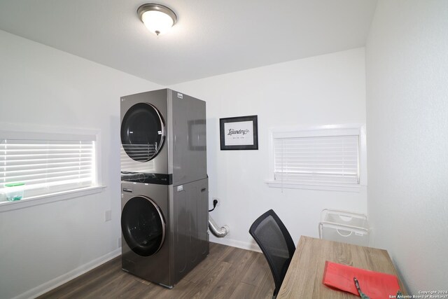 washroom featuring dark hardwood / wood-style floors and stacked washer / dryer