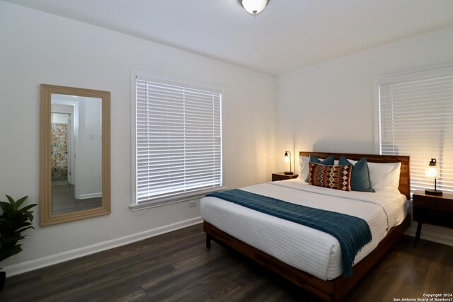 bedroom with dark wood-type flooring