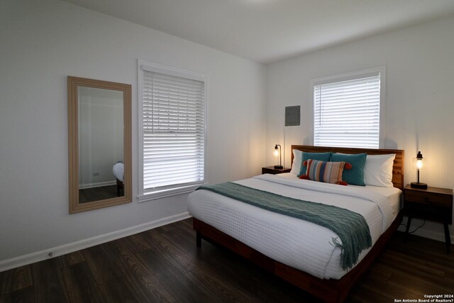 bedroom with dark wood-type flooring