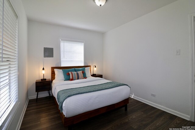 bedroom featuring dark hardwood / wood-style flooring and electric panel