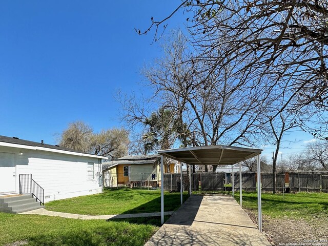 back of property with a yard and a carport