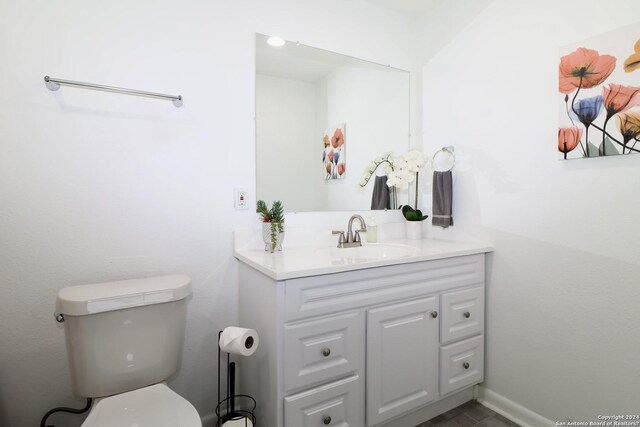 bathroom featuring vanity and toilet