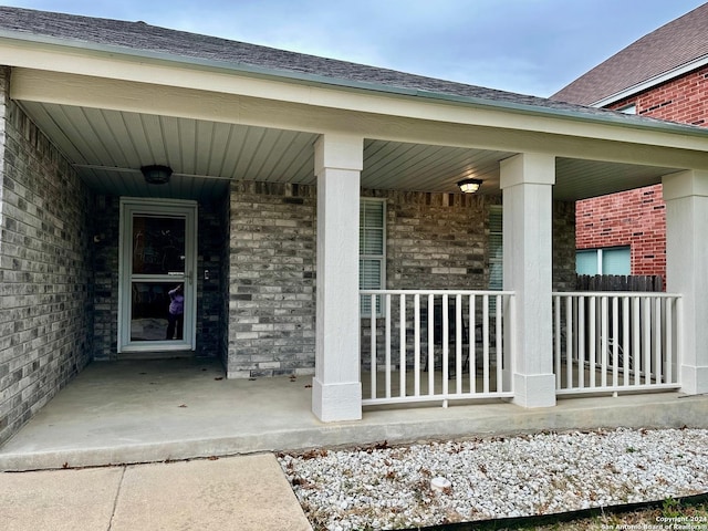 view of exterior entry featuring a porch