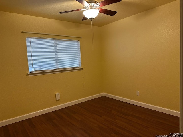 spare room featuring ceiling fan and dark hardwood / wood-style floors