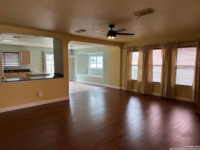 spare room featuring ceiling fan, sink, a textured ceiling, and hardwood / wood-style flooring