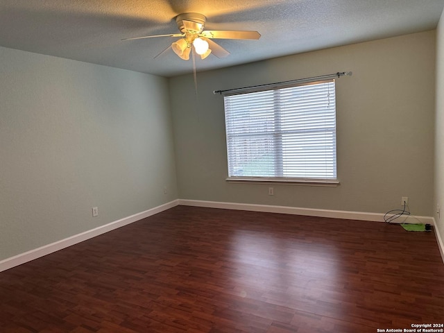 spare room featuring a textured ceiling, dark hardwood / wood-style floors, and ceiling fan