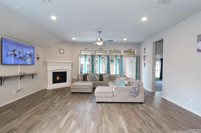 living room featuring lofted ceiling, ceiling fan, and wood-type flooring