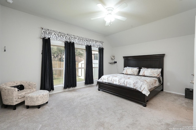 carpeted bedroom with ceiling fan and lofted ceiling