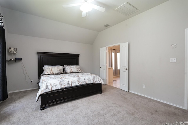 bedroom with ceiling fan, light colored carpet, and lofted ceiling