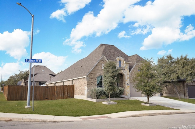 view of front of home featuring a front lawn and a garage