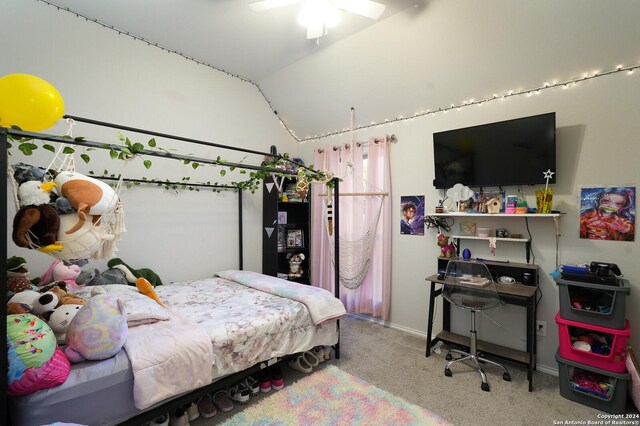 carpeted bedroom with ceiling fan and vaulted ceiling