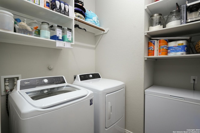 laundry area with independent washer and dryer