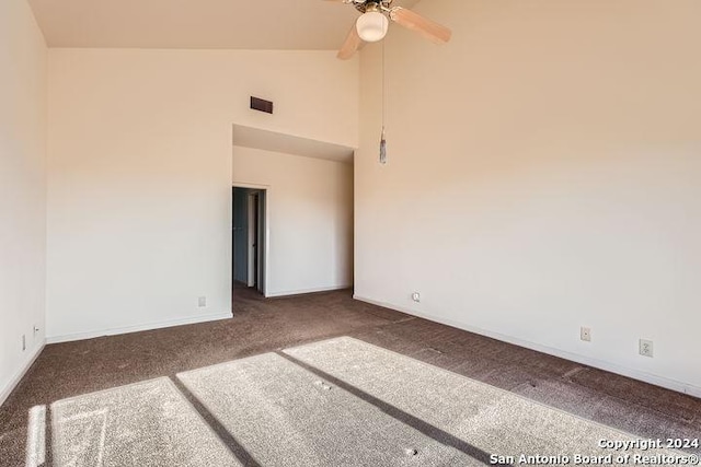 carpeted spare room featuring ceiling fan and high vaulted ceiling