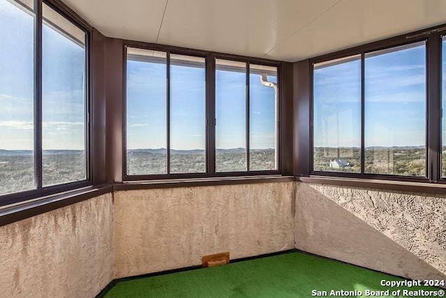 unfurnished sunroom with a wealth of natural light