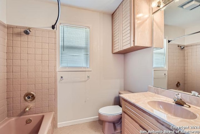 full bathroom featuring vanity, tile patterned floors, tiled shower / bath combo, and toilet